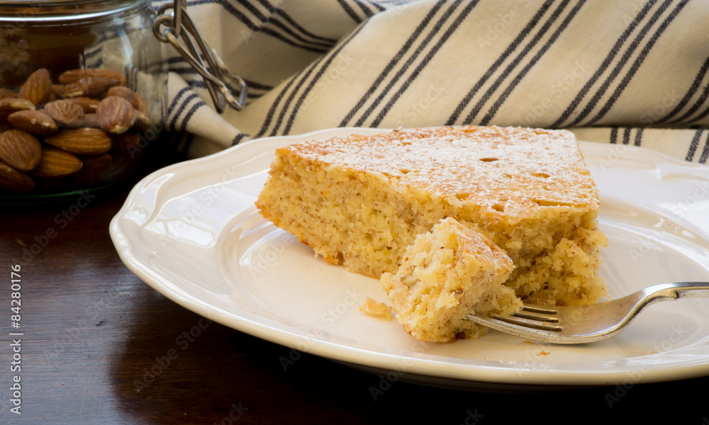 Lemon Almond Cake Slice with Fork on White Plate Lemon Almond Cake Slice with Fork on White Plate