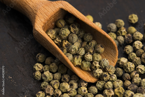 Green Peppercorns on wooden background