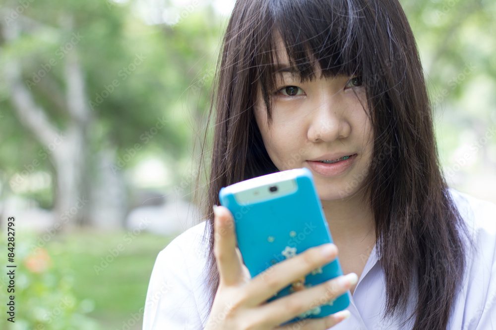 thai student teen beautiful girl using her smart phone thai student teen beautiful girl using her smart phone