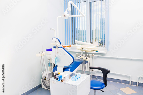 Dentist tools and chair in a dentist office