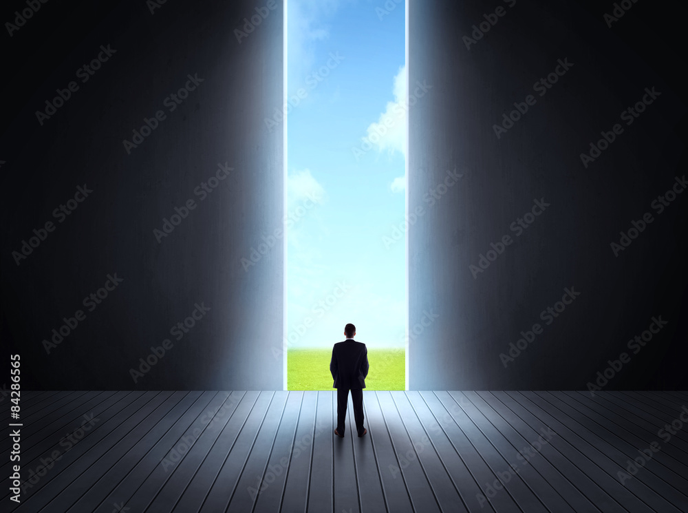 businessman walking to open gate businessman walking to open gate