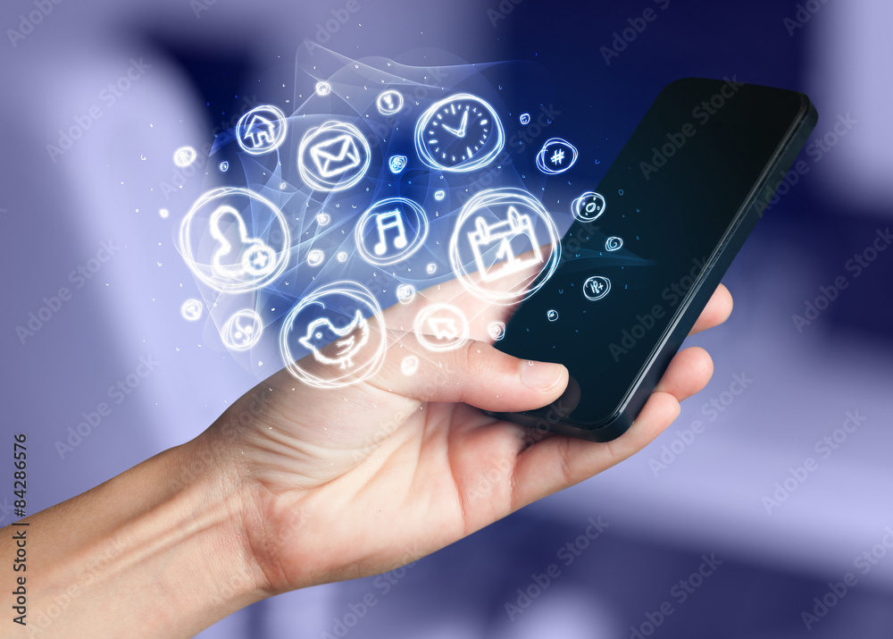 Hand holding smartphone with mobile app choices Hand holding smartphone with mobile app choices