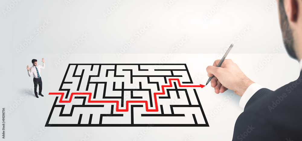 Business man looking at hand drawing solution Business man looking at hand drawing solution