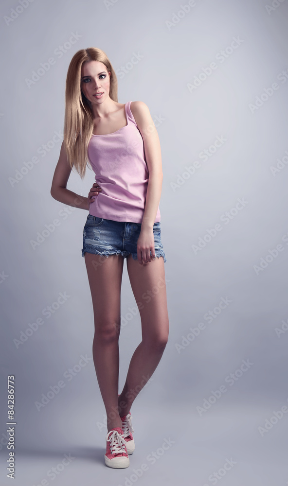 Expressive young model in casual style on gray background Expressive young model in casual style on gray background
