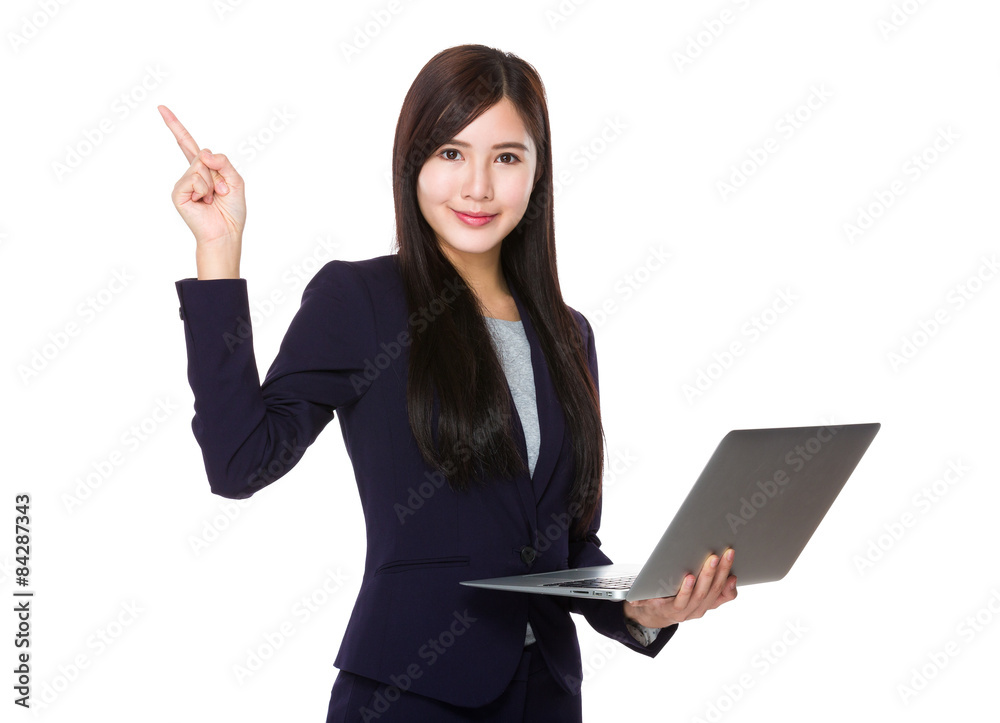 Young businesswoman hold with laptop computer and finger pointin Young businesswoman hold with laptop computer and finger pointin