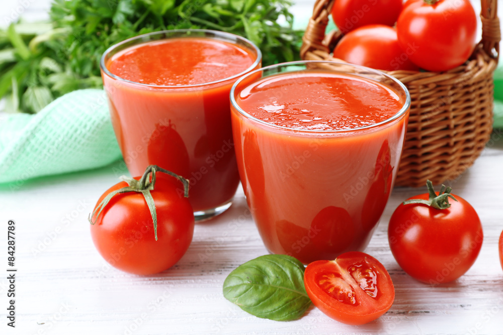 Glasses of fresh tomato juice on wooden table, closeup Glasses of fresh tomato juice on wooden table, closeup