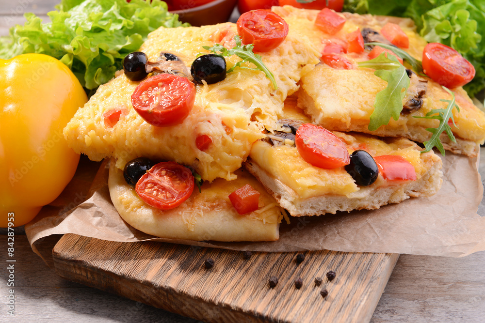 Delicious homemade pizza on table close-up Delicious homemade pizza on table close-up