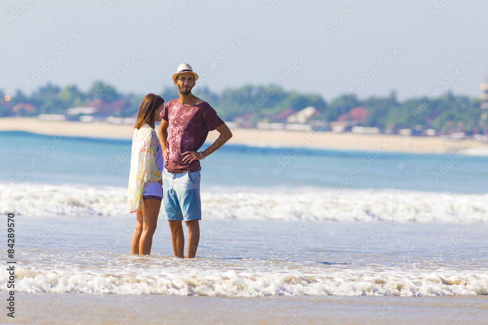 Man in Hat and a girl on a Beach.