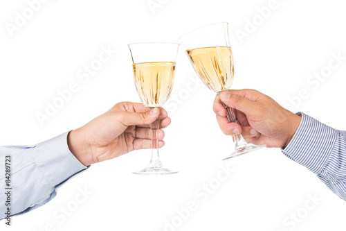 Man in long sleeve shirt toasting white wine in crystal glass
