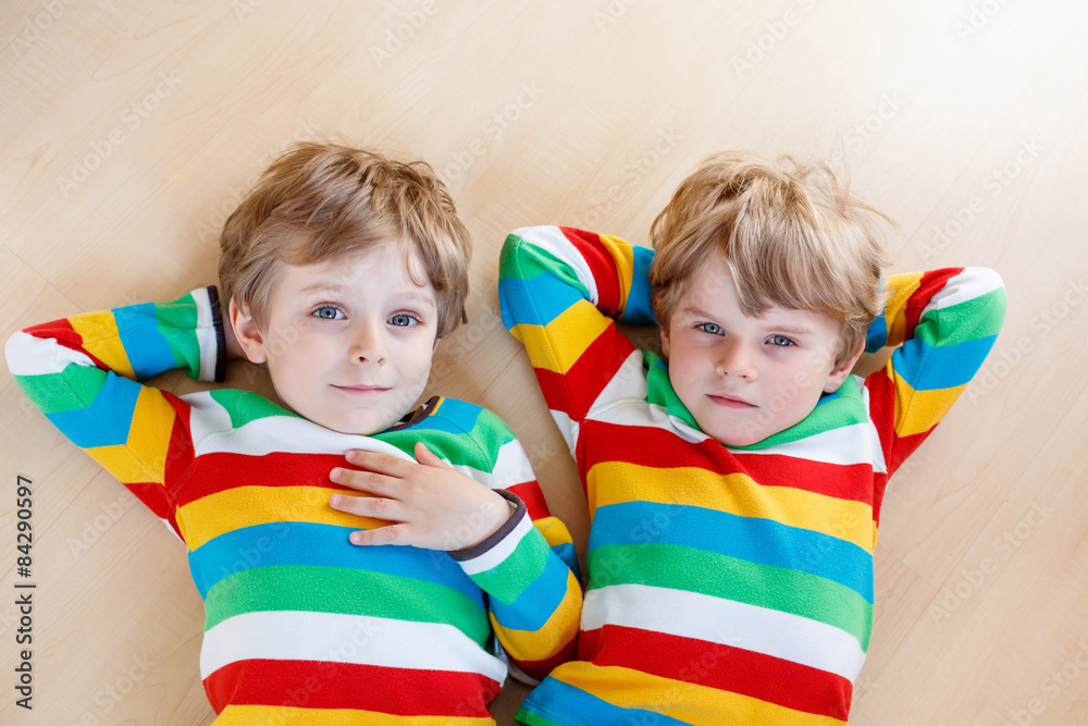 Two little sibling kid boys having fun together, indoors Two little sibling kid boys having fun together, indoors