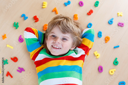 Kid boy with colorful numbers, indoor