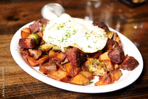 Corned beef hash with brussel sprouts and eggs over easy.