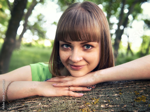 Young sensual girl leaning against a tree photo