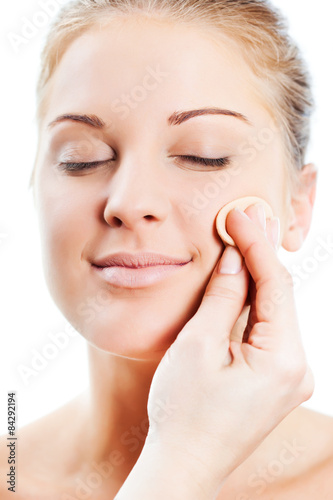 Beautician artist applying face powder