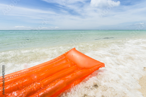 orange air mattress in the sea