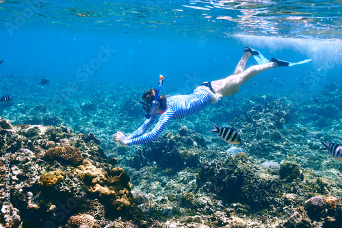 Woman with mask snorkeling photo