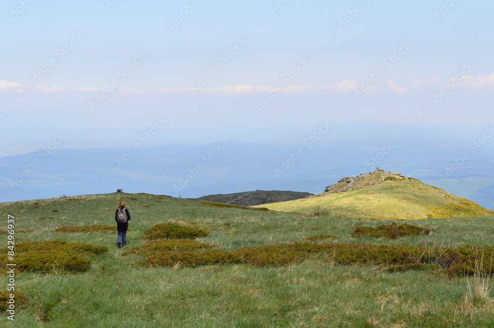 Single Woman Walking On Wide Mountain Plateau Single Woman Walking On Wide Mountain Plateau