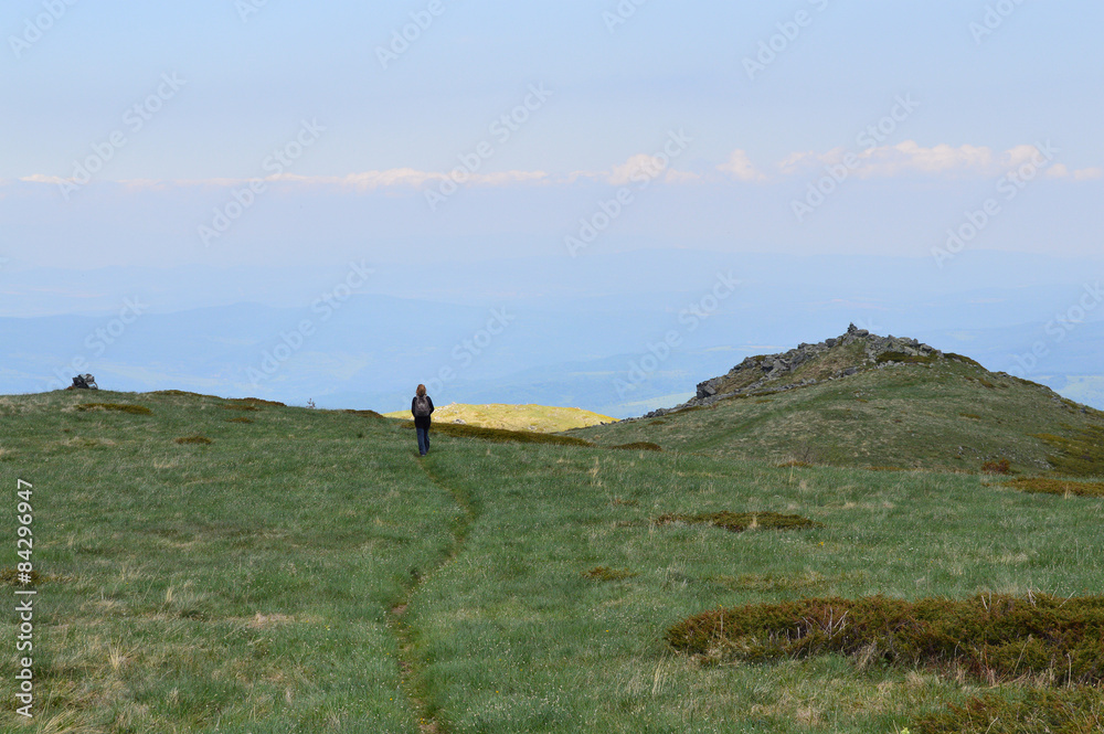 Woman Walking On Wide Mountain Plateau