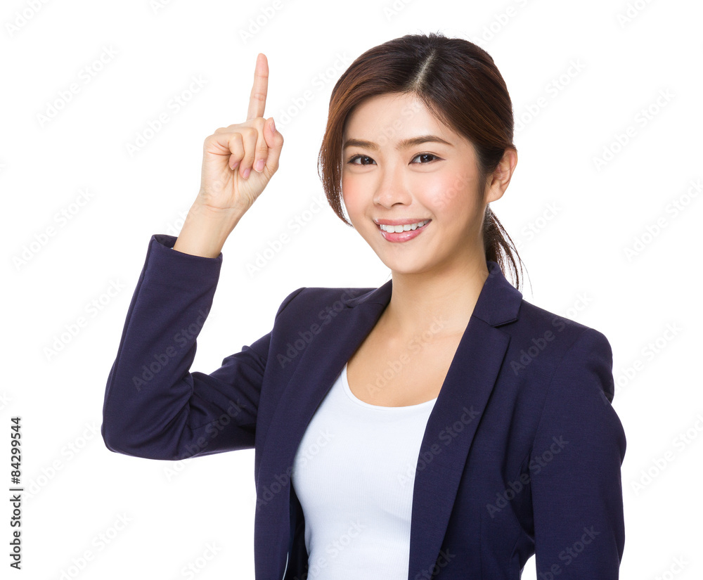 Asian businesswoman with finger pointing upwards Asian businesswoman with finger pointing upwards