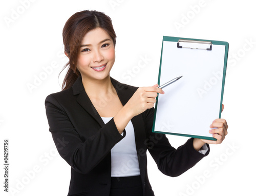 Businesswoman pen pointing to the blank page of clipboard