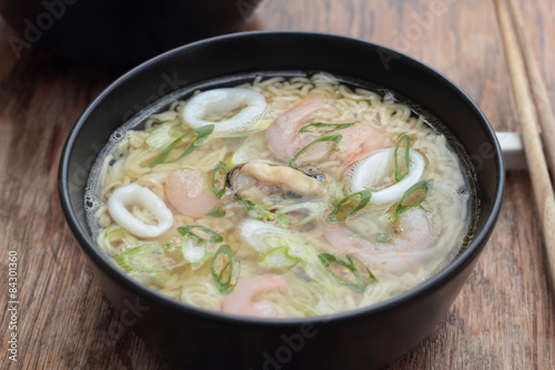 Bowl of oriental noodle and seafood soup.