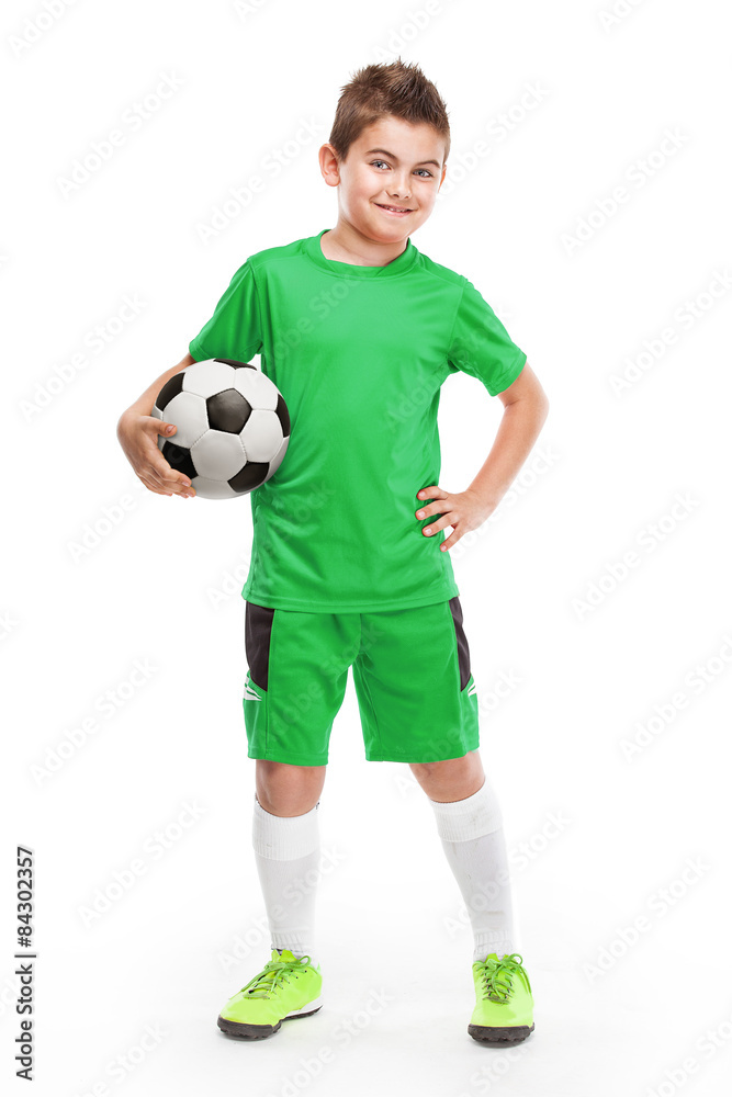 standing young soccer player holding football