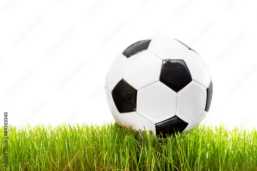 White and black football on a grass surface