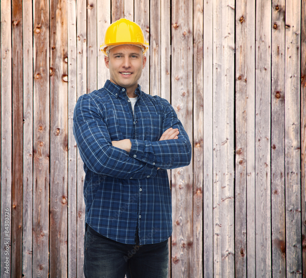 smiling male builder or manual worker in helmet smiling male builder or manual worker in helmet