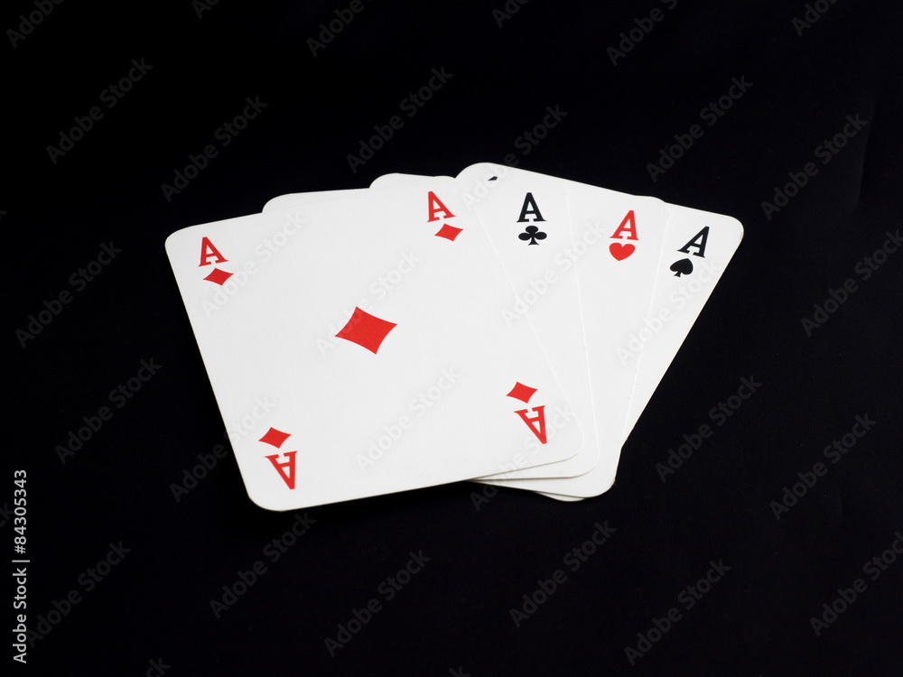 Four aces on black background