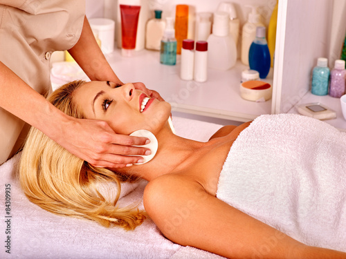 Woman getting facial massage .