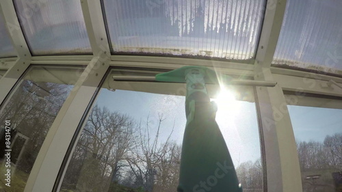 Hand spray cleaner liquid wipe window with squeegee tool. 4K
 photo