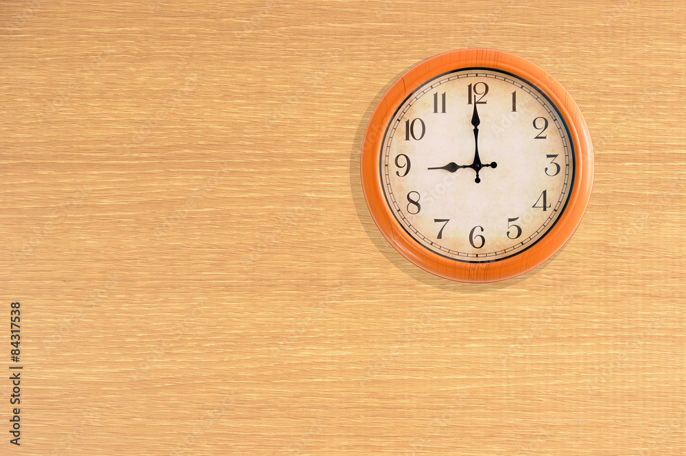 Clock showing 9 o'clock on a wooden wall Clock showing 9 o'clock on a wooden wall