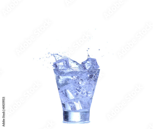 Glass of water, ice and slice of fresh lemon on a white background