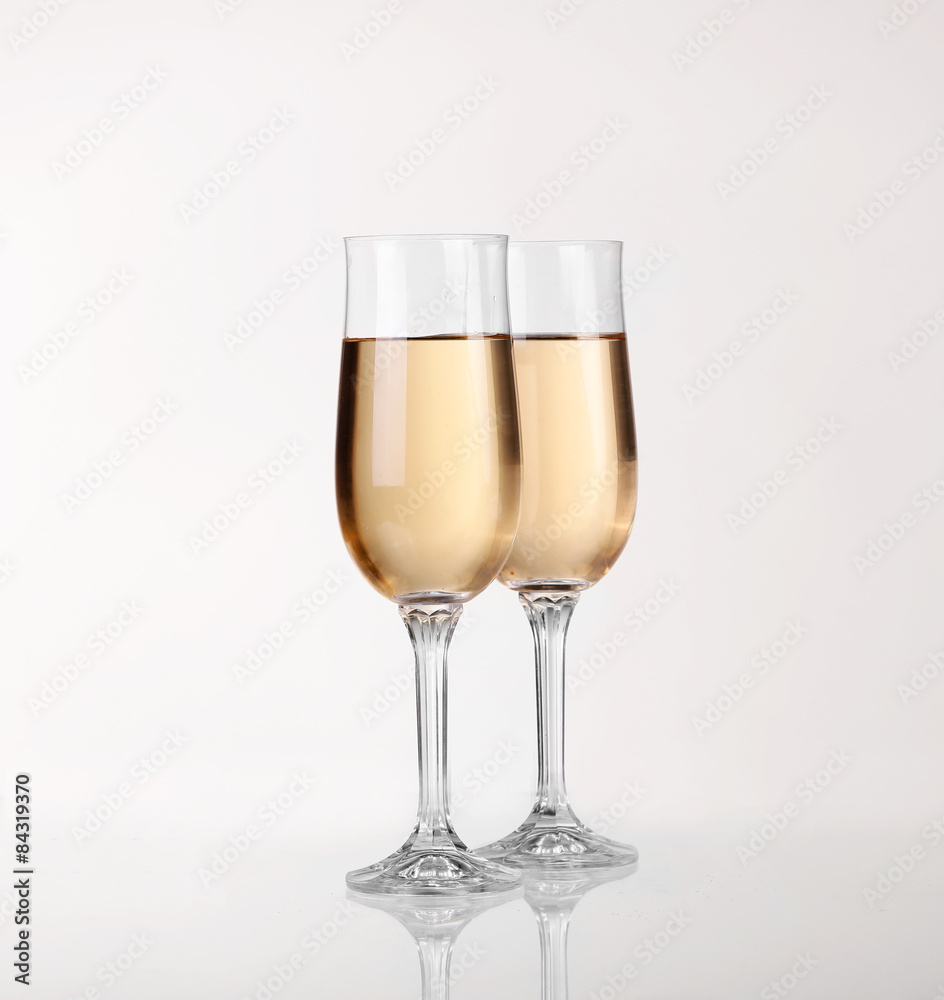 Two glasses of champagne over light gray white background Two glasses of champagne over light gray white background