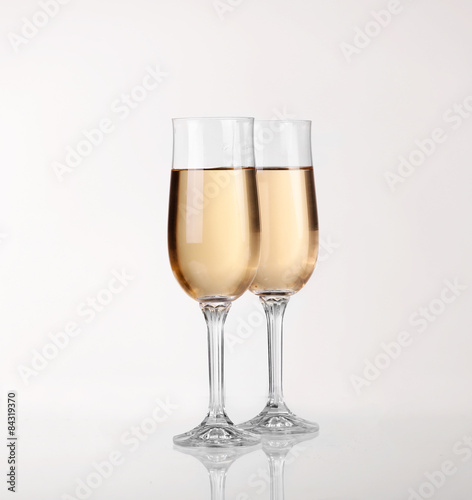 Two glasses of champagne over light gray white background