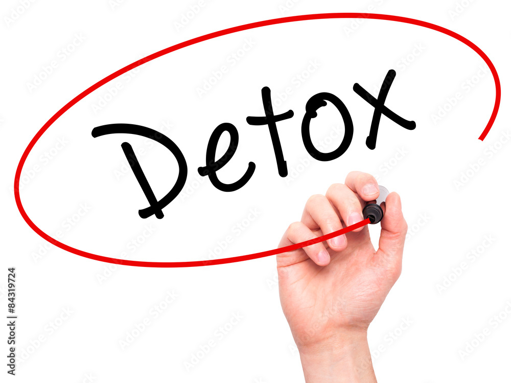 Man Hand writing Detox with marker on transparent wipe board Man Hand writing Detox with marker on transparent wipe board