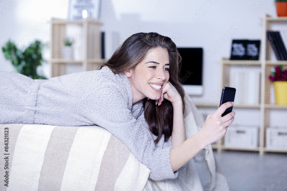 Woman in bed with tablet laughing Woman in bed with tablet laughing