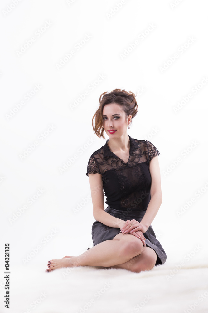 Smiling woman sitting on white background Smiling woman sitting on white background