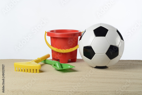 Articulos de playa y balón de fútbol en la arena photo