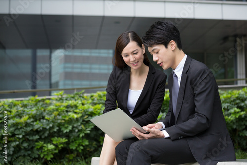 Photography Businessman read on notebook computer with businesswoman