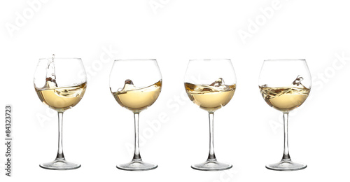WHITE wine swirling in a goblet wine glass, isolated on a white