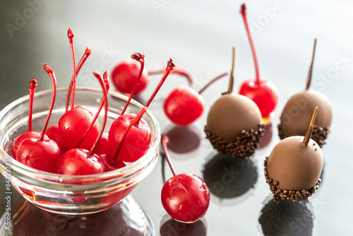 Chocolate and cocktail cherries on the glass photo