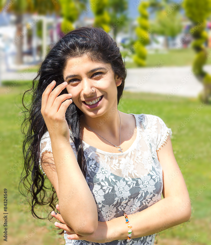 smiling young beautiful woman posing outdoors