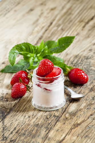 Homemade strawberry yogurt with fresh strawberries and mint in a