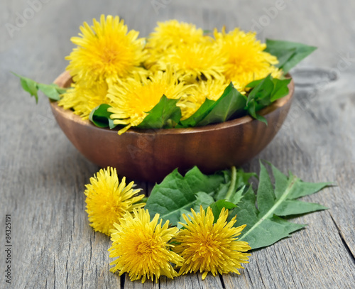 Dandelions on wooden table
