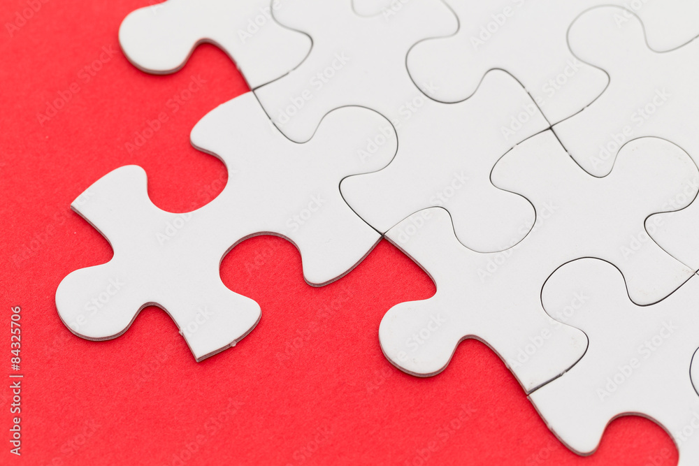 Plain white jigsaw puzzle on red background Plain white jigsaw puzzle on red background