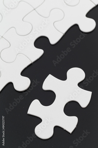 White puzzle on black background