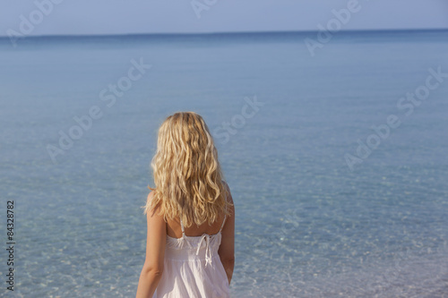 woman meditating and relaxing on beach