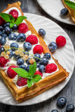 Waffles with fresh berry fruit and mint leaf