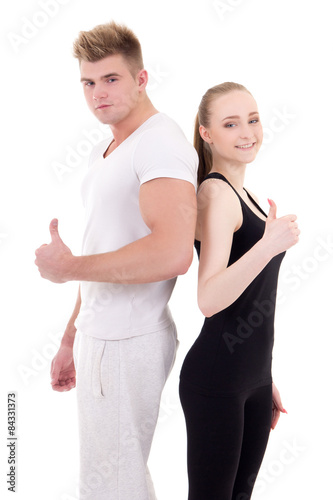 portrait of young man and woman in sportswear thumbs up isolated © Di Studio